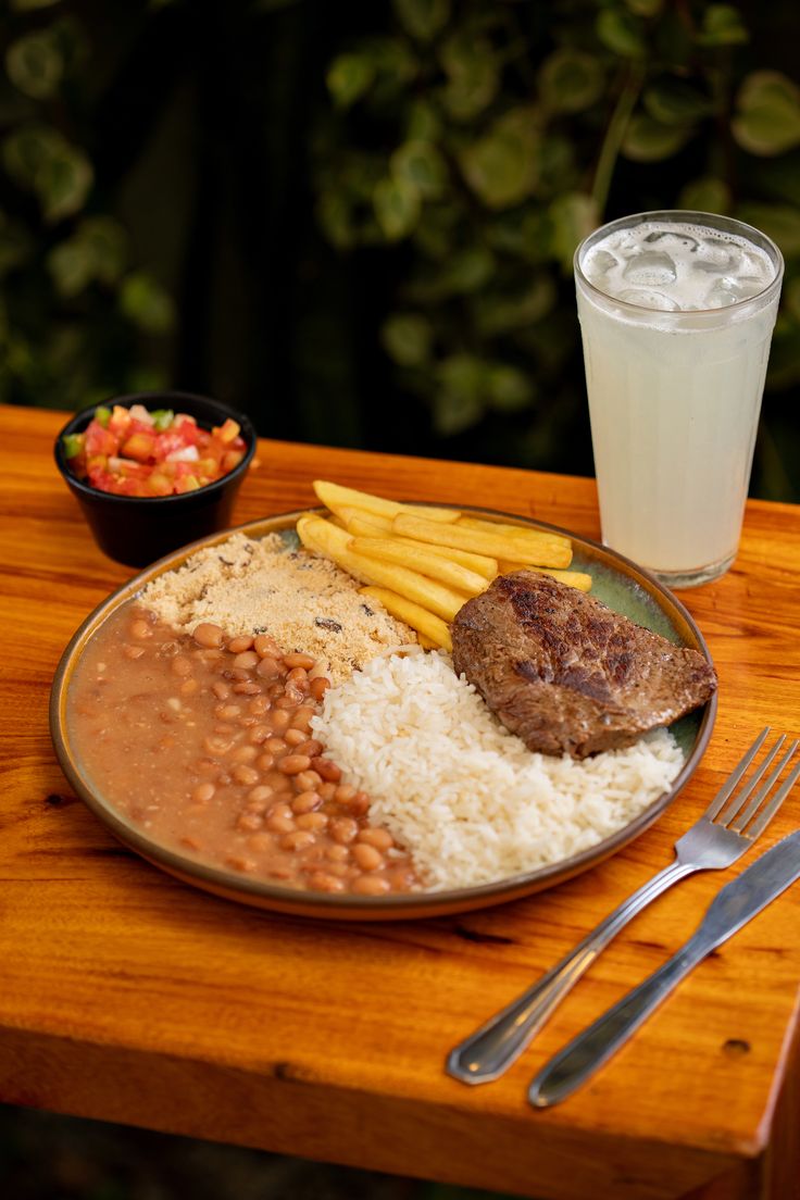 Prato feito comercial clássico com arroz, feijão, bife e batata frita.